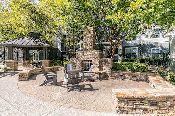 A patio with a fireplace and seating area  at Willowest at Lindbergh in Atlanta, GA