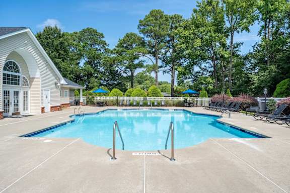 A swimming pool in front of apartment buildings.