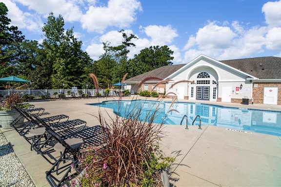 A swimming pool in front of apartment buildings.