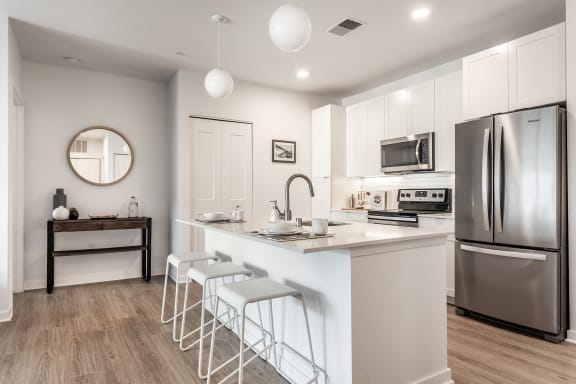 Vim + Vigor Lofts kitchen with stainless steel appliances and hardwood floors Apartments in Milwaukee, WI