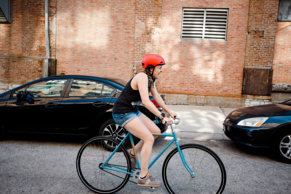 a woman riding a bike on a city street