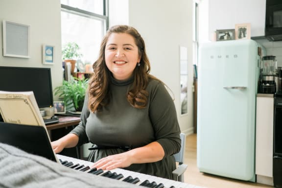 a woman is standing in front of a keyboard