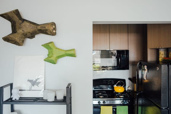 a kitchen with a stove and a refrigerator and some deer decorations on the wall