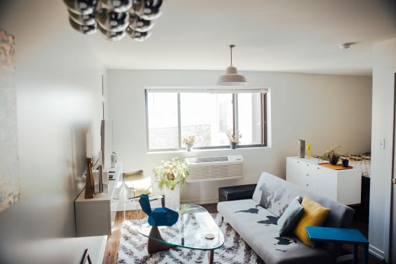 a living room with a white couch and a glass table