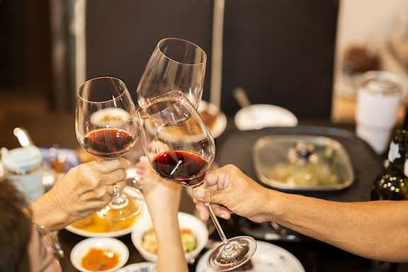 A group of people toasting with wine glasses at The Landmark, Texas