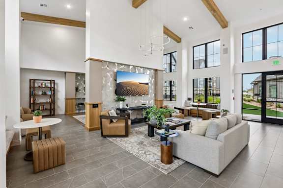 A spacious living room with a large couch, a coffee table, and a fireplace.