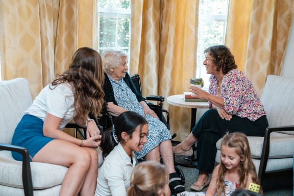 a group of children and an elderly woman in a wheelchair
