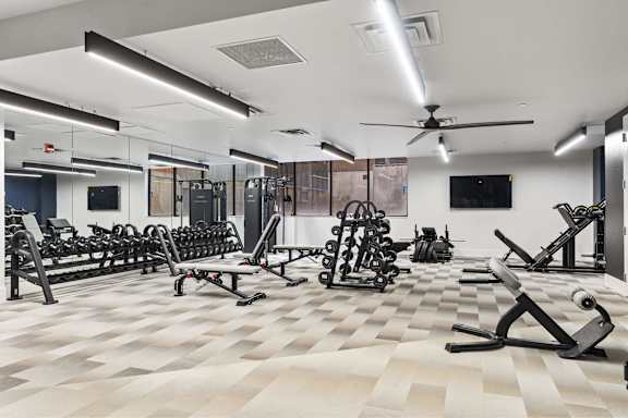 Spacious gym with a variety of equipment at Brickside Heights, Millcreek