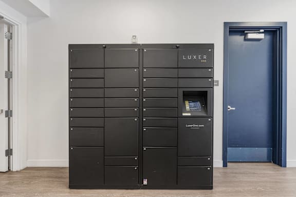 A black LUXER storage unit with a door on the right. 605 Place Student Housing & Co-Living, St George