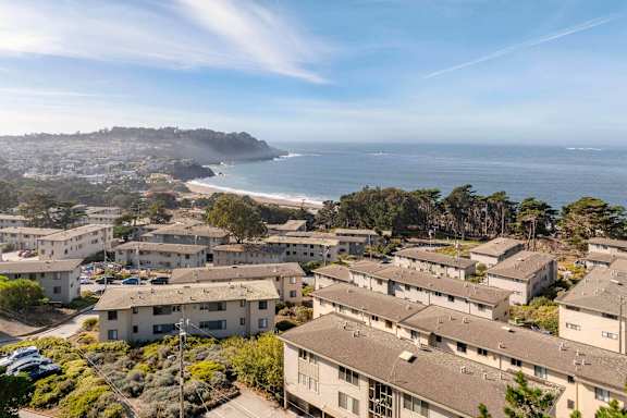 A coastal residential area with houses and a beach.