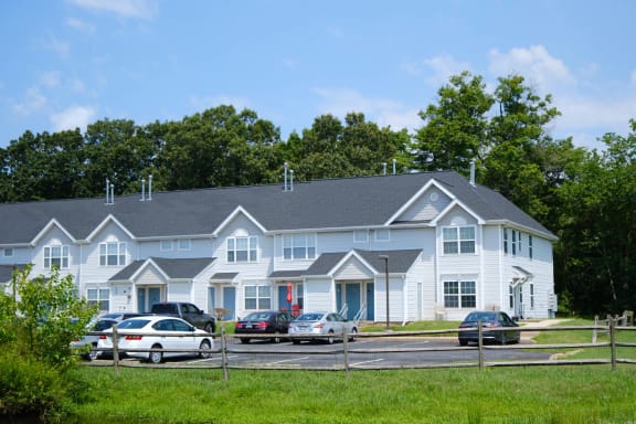 a large white house with cars parked in front of it