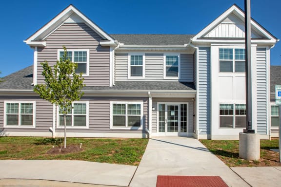 a large house with a sidewalk in front of it
