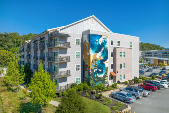 A large white building with a mural on the side at Skyloft in Asheville, NC 28803