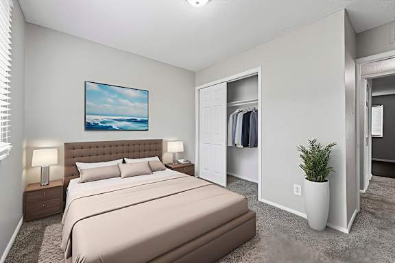A bedroom with a large bed and a painting on the wall.at Signature Collection, Tuscaloosa, AL 35405