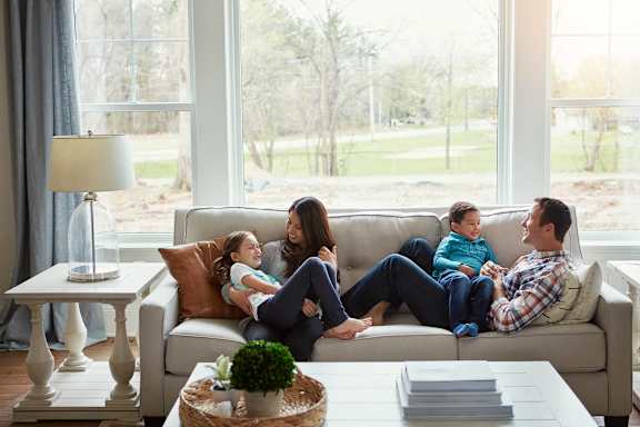 a family sitting on a couch in a living room
