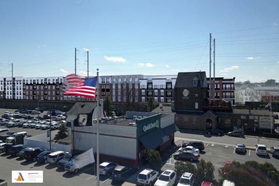 an flag flying over a building in a parking lot
