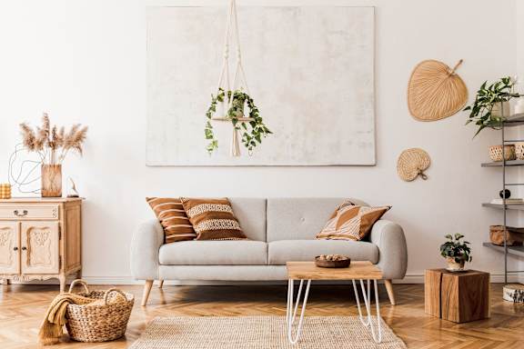 a living room with a couch and a wreath on the wall