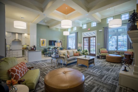 a living room with couches and chairs and a kitchen at Cypress Creek at Joshua Station, Joshua