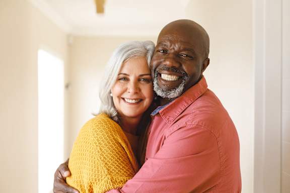 Older couple is hugging at Sweetwater Terraces Apartments, Duluth