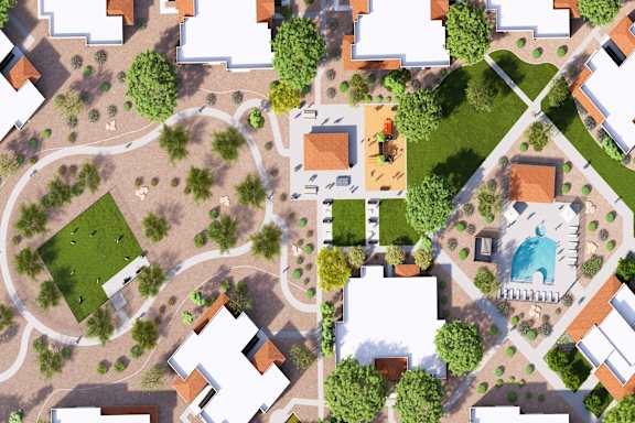 A bird's eye view of a residential area with houses, roads, and green spaces.