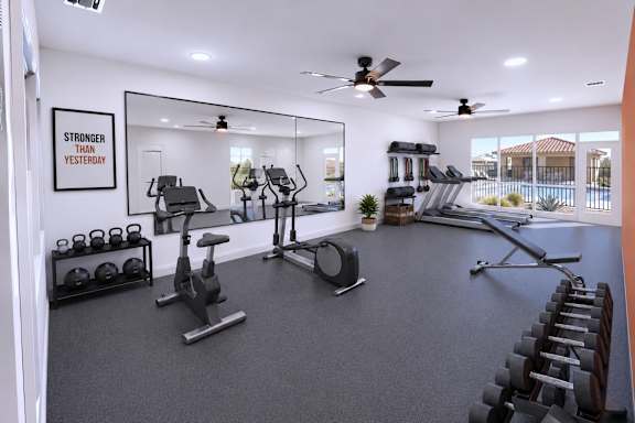 A gym with a mirror, weights, and cardio equipment.