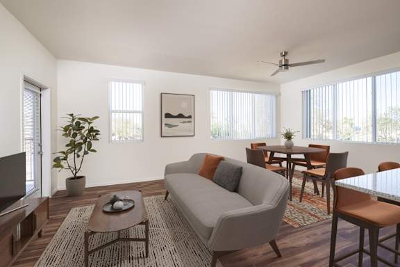 A living room with a grey couch, a coffee table, and a television.