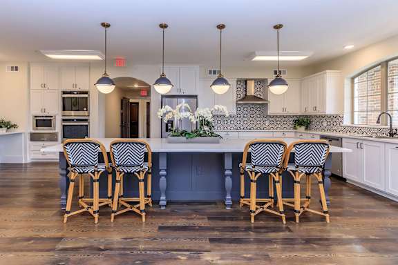 a large kitchen with a large island and chairs at Mariposa at Westchester, Grand Prairie