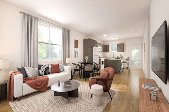 A modern living room with a white sofa, a coffee table, and a television.