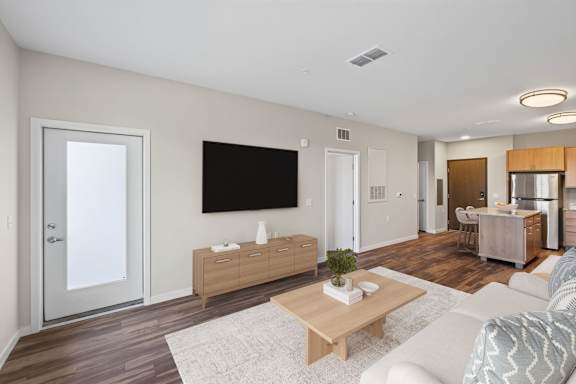 A modern living room with a flat screen TV mounted on the wall.