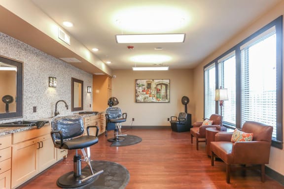 a salon room with chairs and a sink and a large windowat Mariposa at Harris Road Arlington 55+ Apartments, Arlington, TX