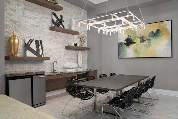A modern kitchen with a dining table and chairs.