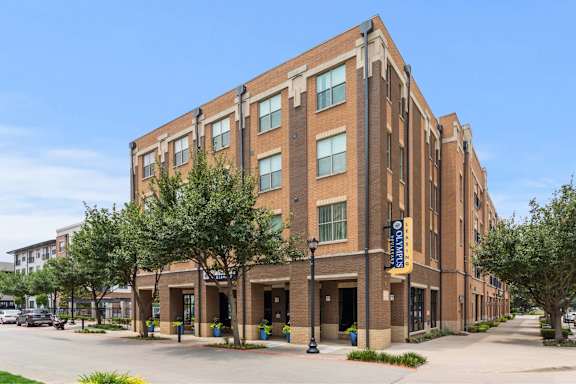 A large brick building with a yellow sign on the front.
