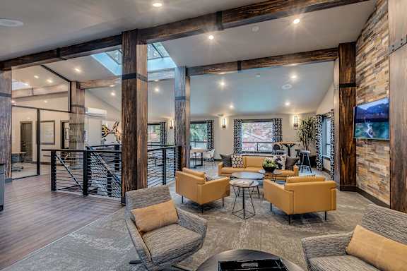 A modern living room with a wooden floor and furniture.