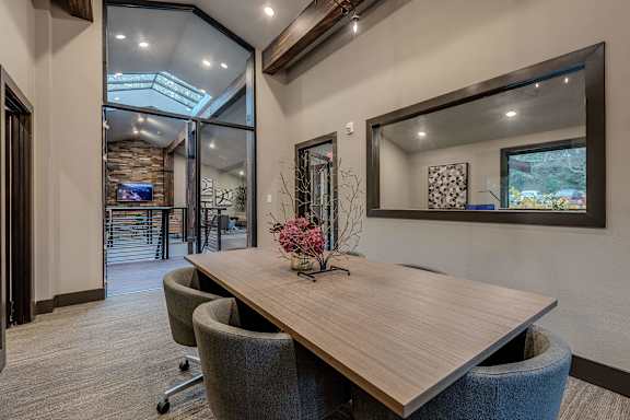 A conference room with a long table and chairs.