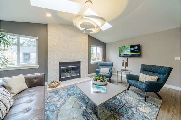 A living room with a fireplace and a television.