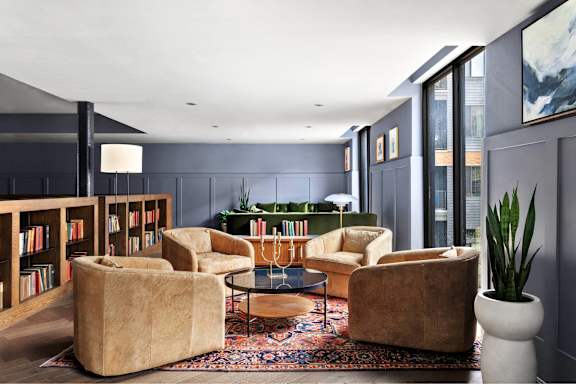 A living room with a large rug and a coffee table.