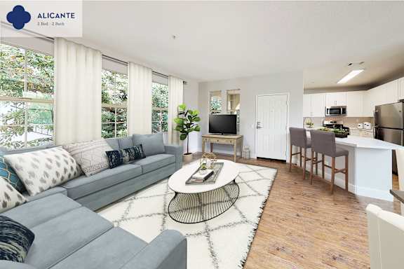 A living room with a grey sofa and a coffee table in the middle.