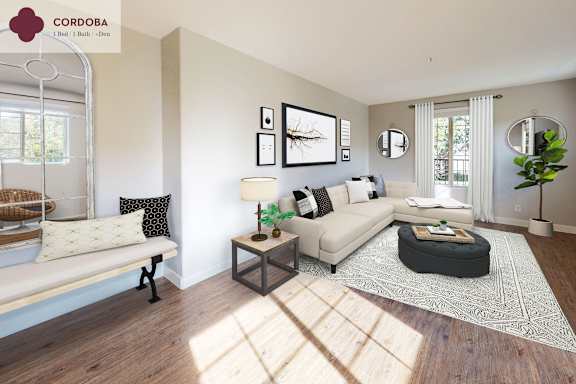 A living room with a white couch, a coffee table, and a rug.
