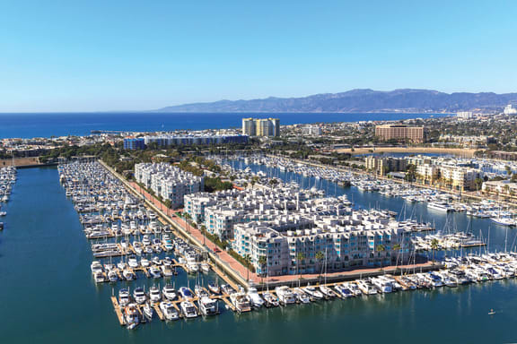 an aerial view of a marina filled with boats
