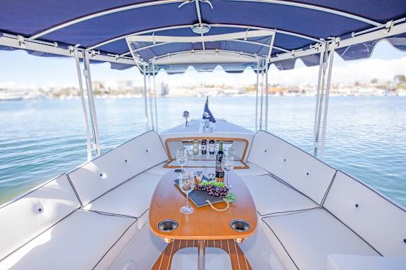 A boat's dining area with a table set for two.