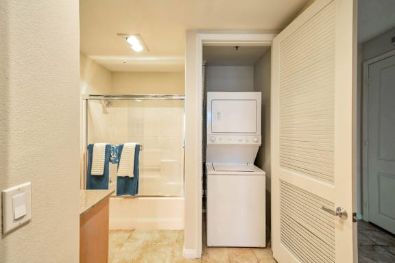 A white washer and dryer in a small bathroom. at Marina Harbor, Marina del Rey, CA, 90292