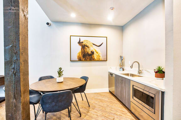a dining room with a table and chairs and a bull on the wall at Mountain Vista, Victorville, California