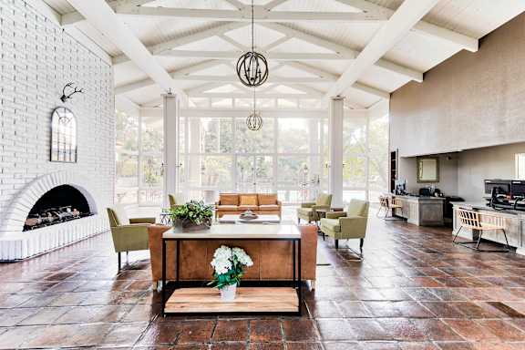 A living room with a fireplace and a couch. at Mediterranean Village Costa Mesa, Costa Mesa