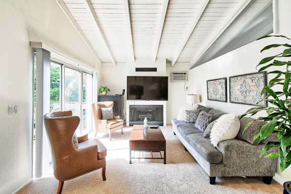 a living room filled with furniture and a large window at Mediterranean Village Costa Mesa, Costa Mesa, CA, 92626