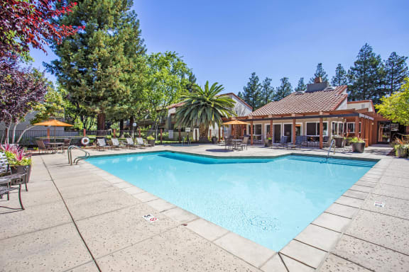 a swimming pool in front of a house with a pool at Valley Plaza Villages, Pleasanton, 94566