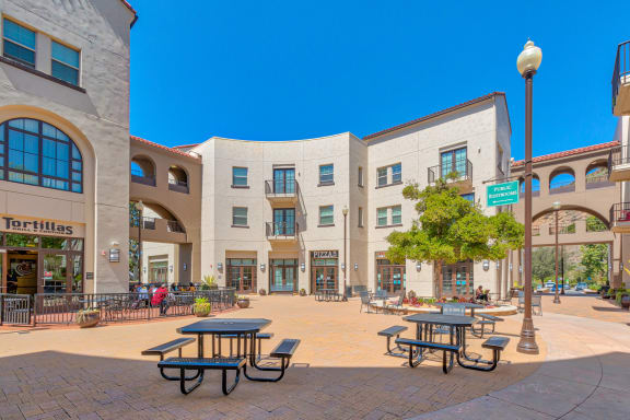 a city square with tables and benches in front of a building  at Mission Hills, Camarillo, CA, 93012