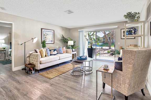 A living room with a white sofa and a wooden coffee table.