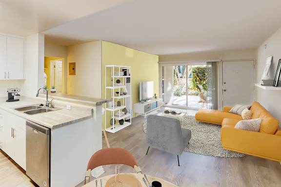 A modern kitchen with a dining area and a living room.