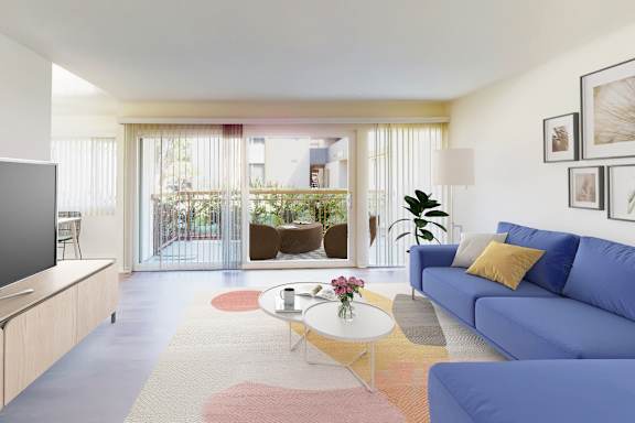 A living room with a blue couch and a television.