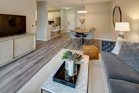 A modern living room with a grey sofa and a coffee table.